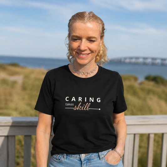 T-shirt feminina de algodão orgânico "Caring takes skill"